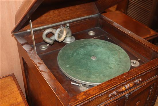 A 1920s oak cabinet, wind-up gramophone and 78 rpm records gramophone W.58cm